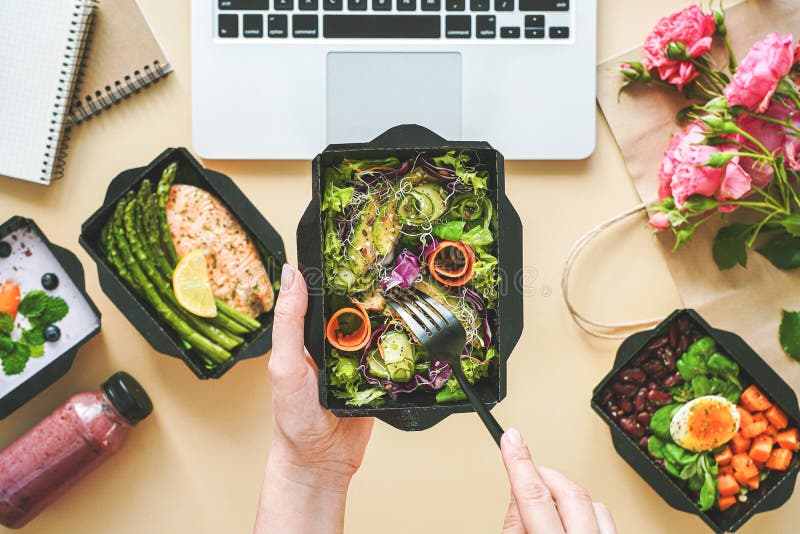 Female Hands Hold Food Delivery Box Having Lunch At Work From Home
